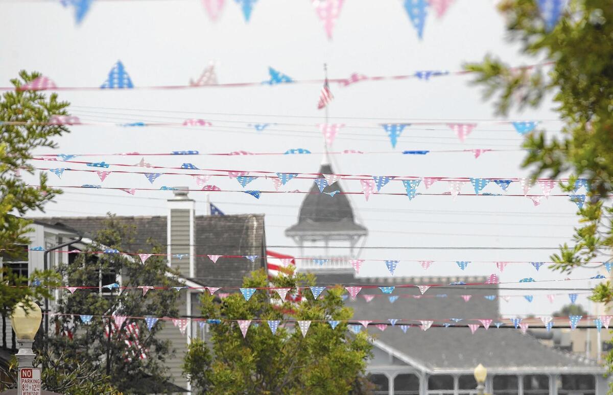 Fourth of July banners are strung house to house across Topaz Street on Balboa Island.