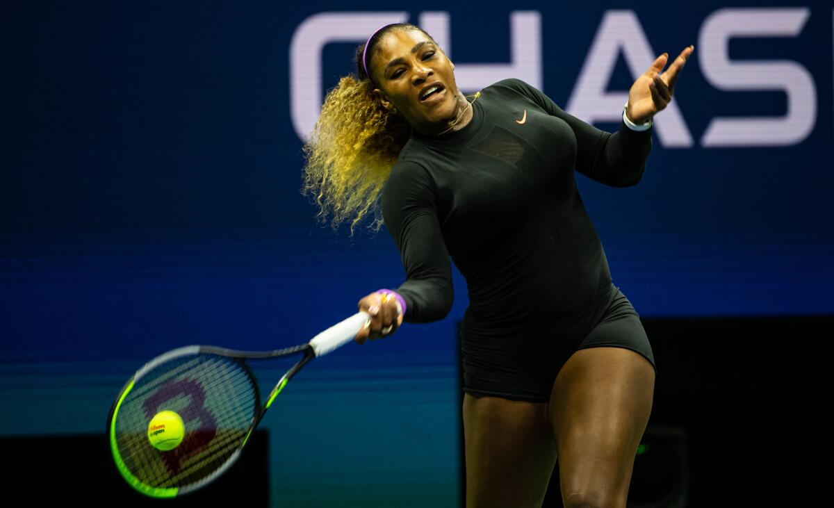 Serena Williams hits a forehand during her victory over Maria Sharapova in the first round of the U.S. Open on Monday.