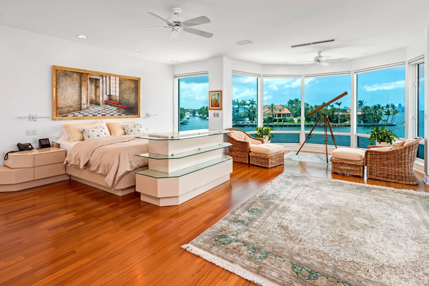 Typical for luxury listings in the Miami area, the home is a sleek mix of tile floors, crisp white walls and glass — lots and lots of glass.