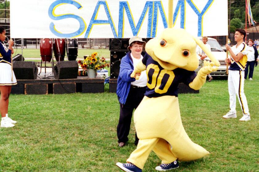 UC Santa Cruz Chancellor M.R.C. Greenwood dances with Sammy the Slug during his introduction as the school's new mascot.