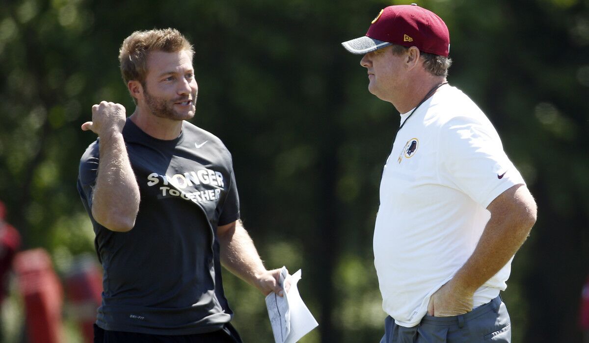 Washington Redskins offensive coordinator Sean McVay, left, talks with Coach Jay Gruden during practice on June 8, 2016.