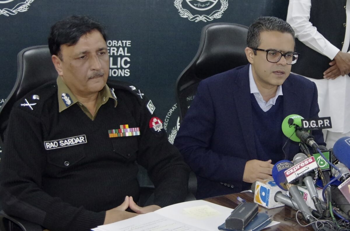 Hassan Khawar, right, spokesman for the Pakistan's Punjab government, and Punjab police chief Rao Sardar brief journalists regarding initial investigation on lynching of a Sri Lankan citizen, in Lahore, Pakistan, Saturday, Dec. 4, 2021. Police arrested 13 suspects and detained dozens of others in the lynching of a Sri Lankan employee at a sports equipment factory in eastern Pakistan, officials said Saturday. (AP Photo)