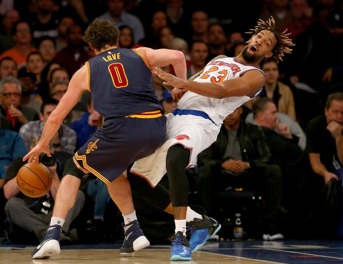 Knicks forward Derrick Williams is run over by Cavaliers forward Kevin Love during a game on Nov. 13.