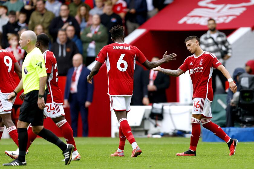 Nottingham Forest's Nicolas Dominguez, right, celebrates scoring their side's first goal of the game during their English Premier League soccer match against Brentford at City Ground, Nottingham, England, Sunday, Oct. 1, 2023. (Nigel French/PA via AP)