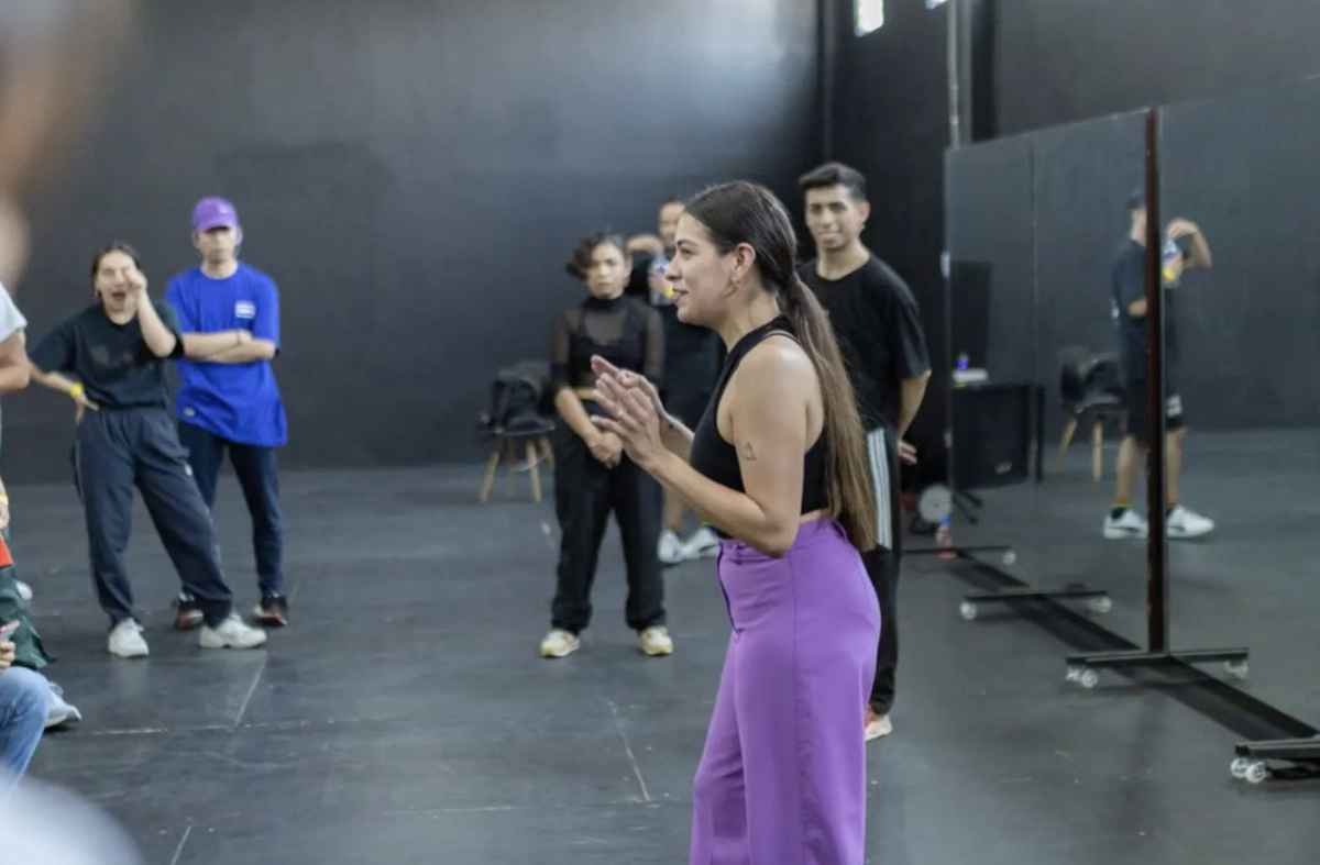 A woman leads a dance class.