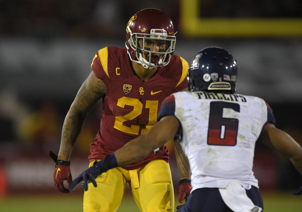 USC linebacker Su'a Cravens, left, gets set against Arizona receiver Nate Phillips on Nov. 8.