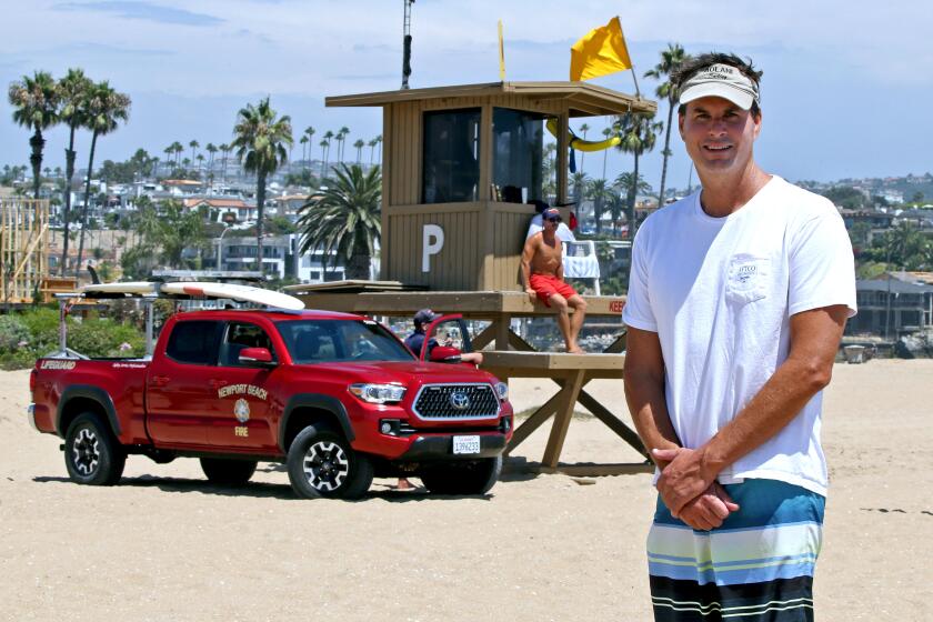 Eric Connella, 53 of Laguna Hills, stands near lifeguard tower P at the Wedge in Newport Beach, on Saturday, Aug. 15, 2020. Connella named the tower as a teenager because back then it was just a half tower and it did not have a name. Connella lived with his parents a couple of blocks away at the time. His parents still live in the home and he visits the area often with his family.