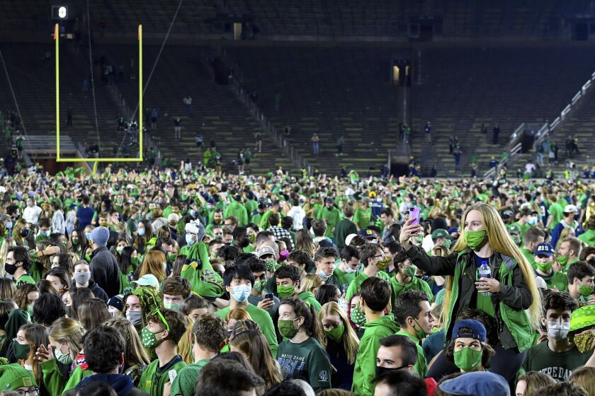 Fans storm the field after Notre Dame defeated the Clemson 47-40 in two overtimes in an NCAA.