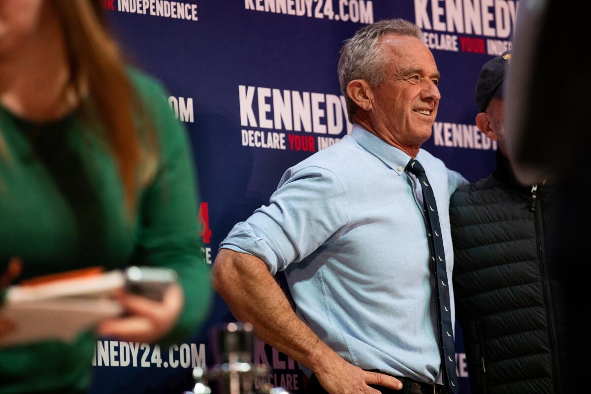 Robert F. Kennedy Jr. poses with supporters in Grand Rapids, Mich.