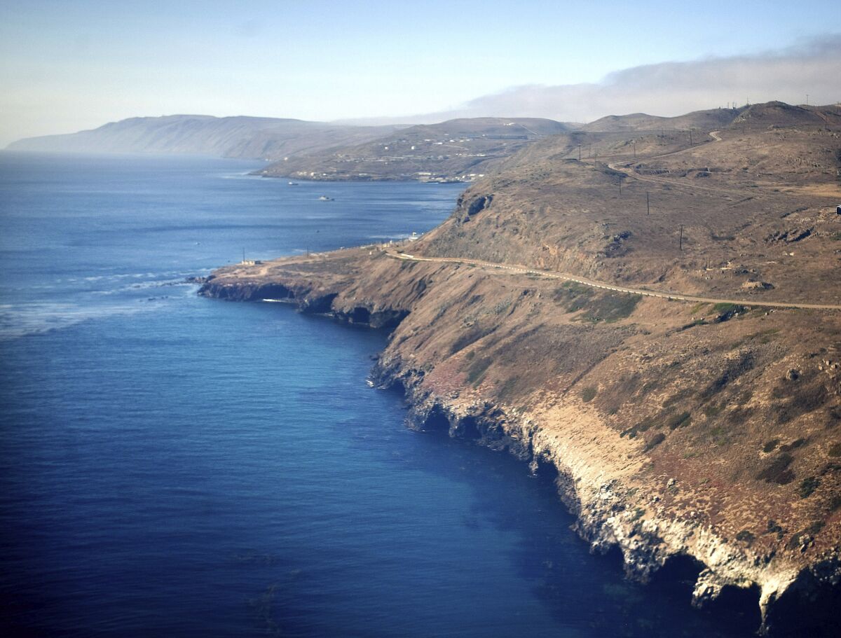 In this July 16, 2013, photo is an aerial view of the coast and Pacific Ocean taken flying in to San Clemente Island, in San Diego. A military seafaring assault vehicle that sank off the coast of Southern California with Marines and one Navy corpsman on board is under hundreds feet of water, making it impossible for divers to reach the landing craft and complicating rescue efforts for the missing troops, officials said Friday, July 31, 2020. (Mindy Schauer/The Orange County Register via AP)