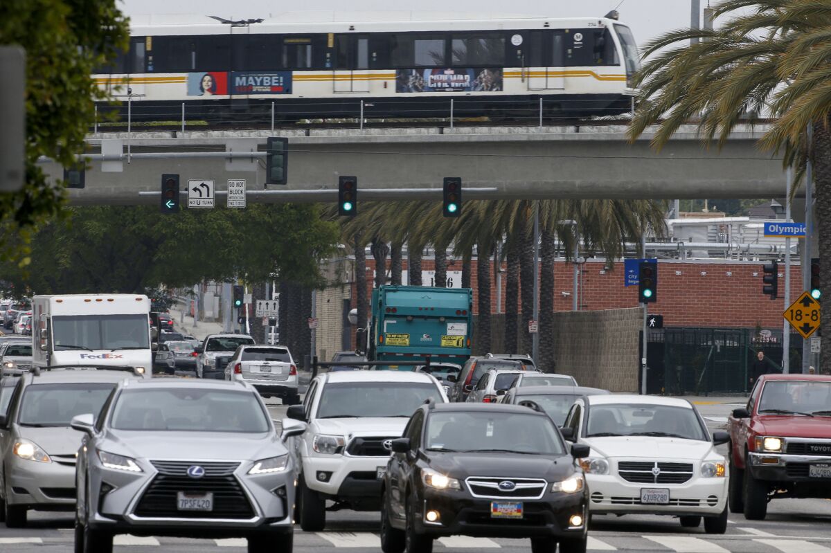 An Expo Line test train passes over a busy and congested Cloverfield Blvd. in Santa Monica on Thursday.