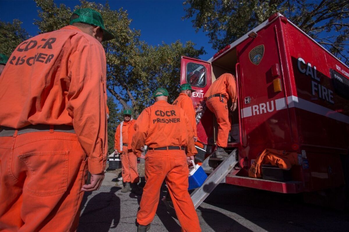 Prisoners at Oak Glen Conservation Camp leave the minimum security prison for work deployment under the authority of Cal Fire, during which time they are called and treated as firefighters rather than inmates until they return to camp, on Sept. 28, 2017 near Yucaipa, California.