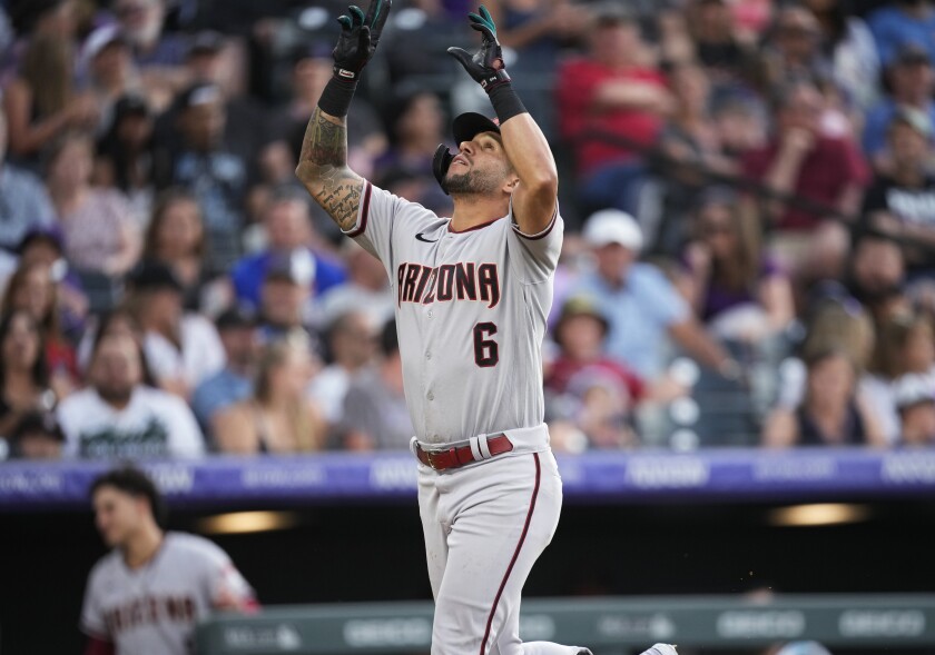 Arizona Diamondbacks' David Peralta gestures as he crosses home plate after hitting a solo home run off Colorado Rockies relief pitcher Ty Blach during the sixth inning of a baseball game Friday, July 1, 2022, in Denver. (AP Photo/David Zalubowski)