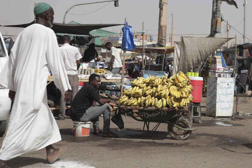 A man sells bananas at a market during a cease-fire in Khartoum, Sudan, Saturday, May 27, 2023. Saudi Arabia and the United States say the warring parties in Sudan are adhering better to a week-long cease-fire after days of fighting. (AP Photo/Marwan Ali)