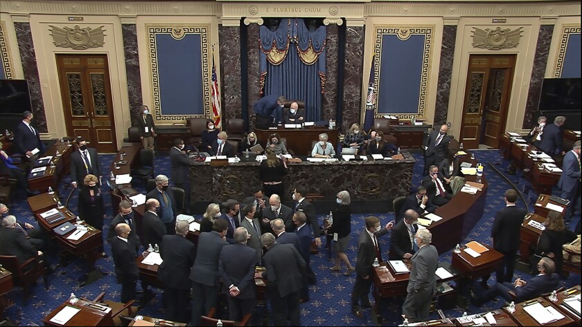 Senators gather in the Senate chamber at the end of the second day of former President Trump's impeachment trial.