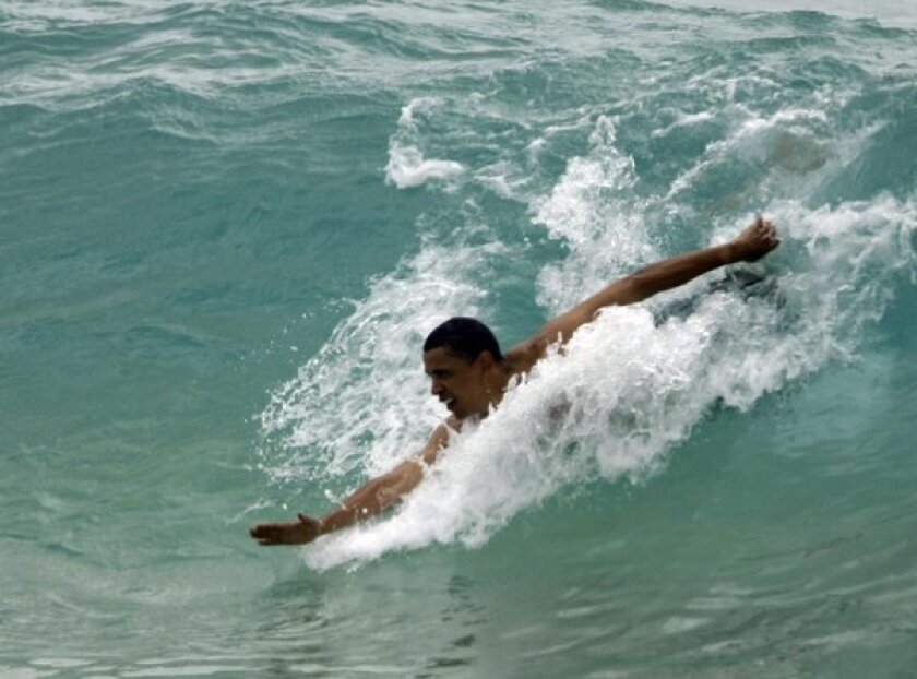Then-Sen. Barack Obama body surfs while vacationing in Hawaii during the 2008 presidential race.