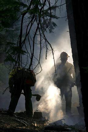 Firefighters put out hot spots in South Lake Tahoe Wednesday afternoon. California officials estimated the fire had caused $150 million in damage and forced 2,000 people from their homes.