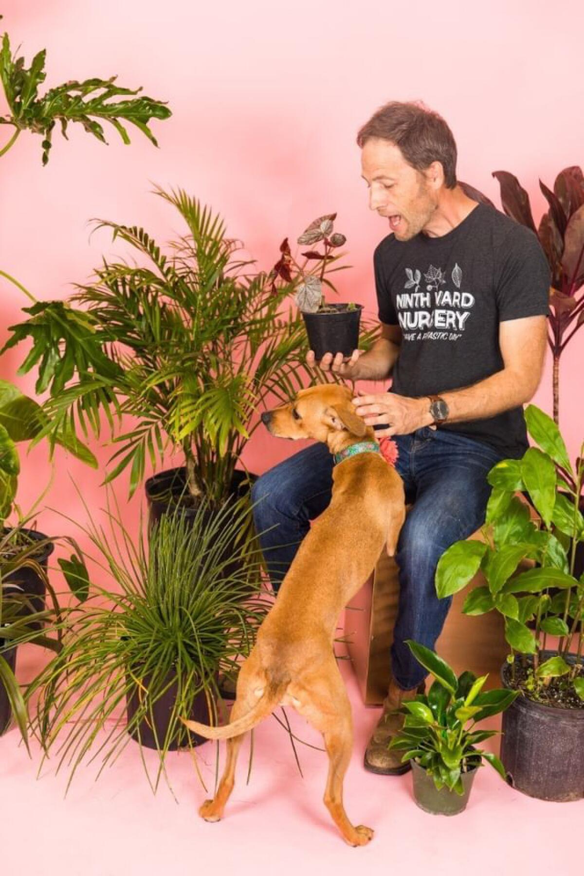 Mark Sanders pictured with his plants and "swamp pup," Wendy