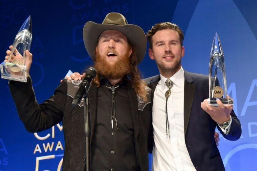 John Osborne, left, and T.J. Osborne of Brothers Osborne, pose in the press room with their hardware for vocal duo of the year at the 50th CMA Awards last month in Nashville.