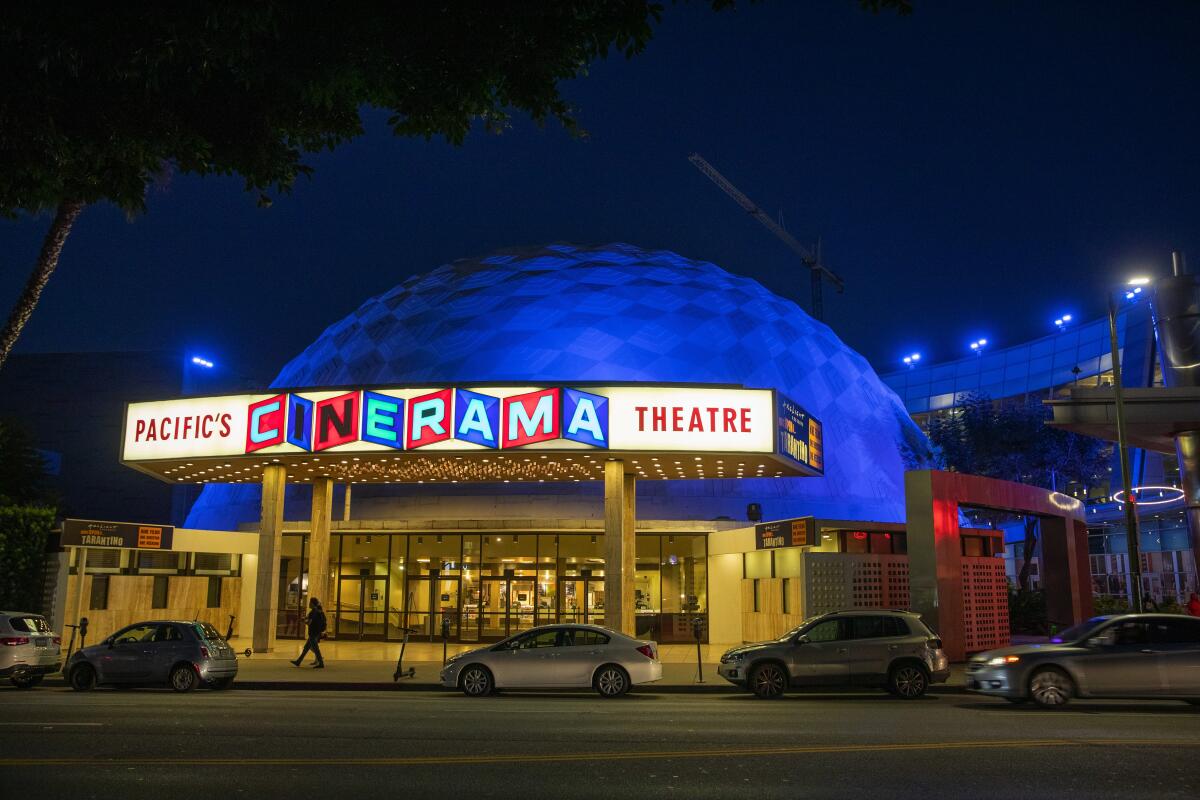 The Cinerama Dome lit up at night.