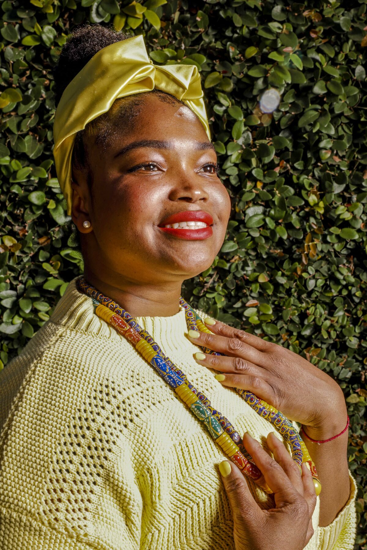 A woman smiles, posing for a portrait