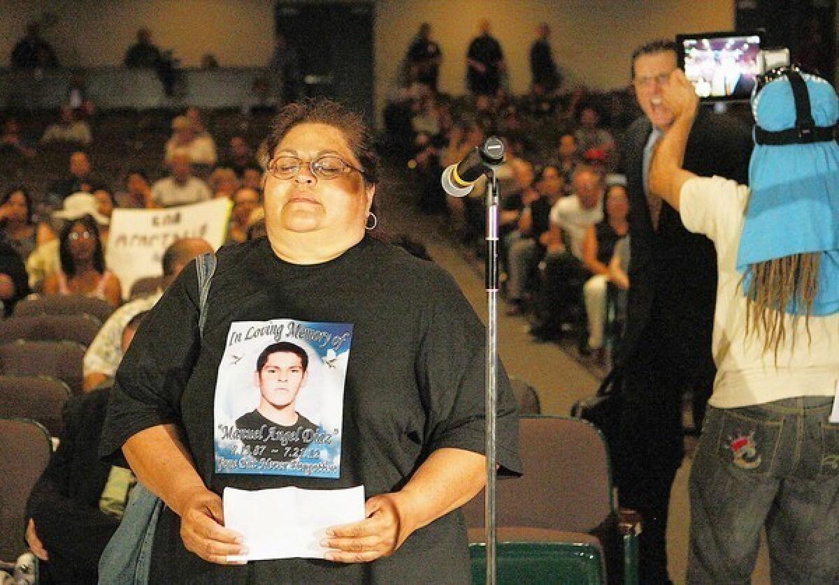 An irate man shouts insults at Genevieve Huizar, the mother of Manuel Angel Diaz, who was killed by Anaheim police. Before the outburst, she told the council: “I want young children to have hope, have peace.”