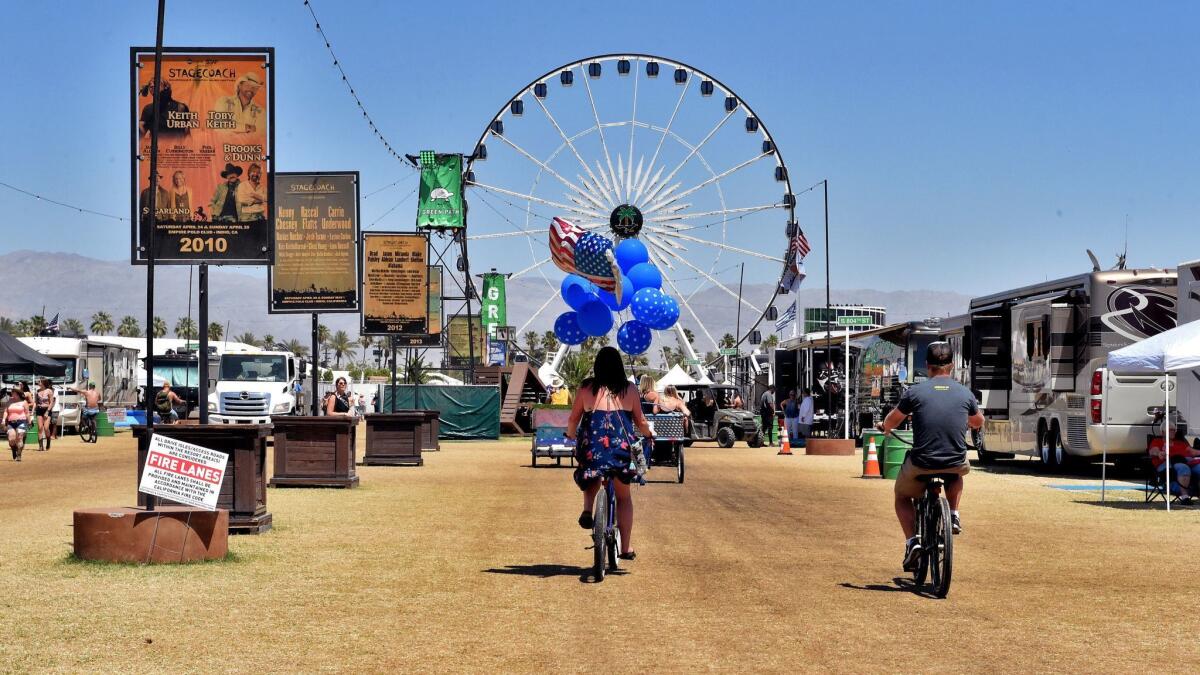 Festival-goers ride bicycles at the Empie Polo Field during Day 1 of the Stagecoach country music festival in Indio.