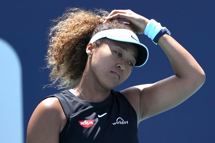 FILE - Naomi Osaka, of Japan, reacts during her match against Maria Sakkari, of Greece, in the quarterfinals of the Miami Open tennis tournament in Miami Gardens, Fla., on March 31, 2021. Osaka says she's been shocked to hear about a fellow player who has gone quiet since making a sexual assault allegation against a former top government official in China. (AP Photo/Lynne Sladky, File)