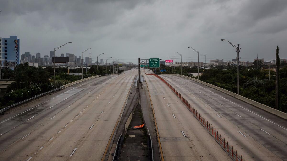 Roadways and freeways sit quiet as people avoid traveling near the time of curfew in Miami on Saturday.
