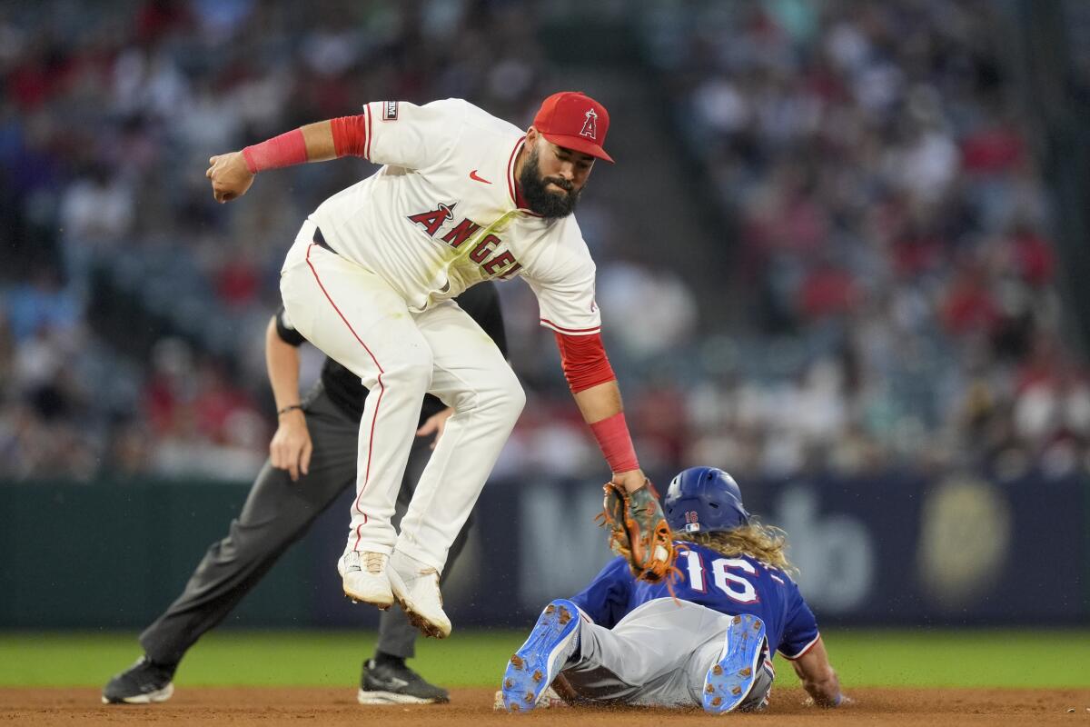 Angels shortstop Luis Guillorme is unable to tag out Texas Rangers baserunner Travis Jankowski.