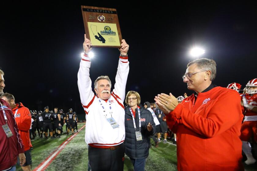 Mater Dei coach Bruce Rollinson celebrates after his team defeated Servite to win Division 1 title.