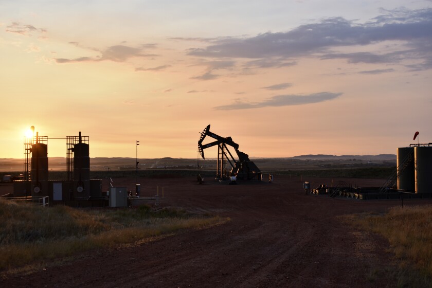 An oil well works at sunrise in Watford City, N.D.