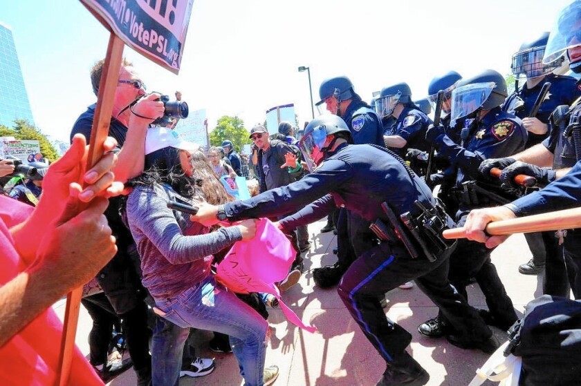 Anti-Trump protesters clash with police Friday outside the California Republican Convention in Burlingame.