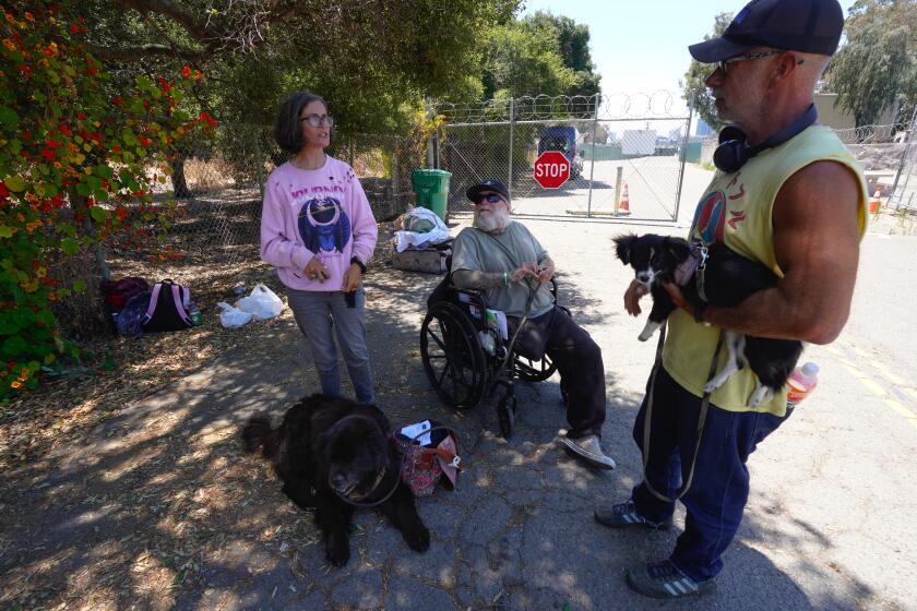 San Diego, CA - June 29: On Thursday, June 29, 2023 just outside the entrance gate for San Diego’s Safe Sleeping Program, Jason Henning and his wife, Regina Henning along with their good friend, Brian Moore were first in line to enter into the shelter. The trio arrived at 5:30 and waited more than six-hours outside before the sheltered opened. The group was referred by staff from Father Joe’s Villages when they were living on the streets in the Gaslamp Quarter. Henning and his wife became homeless when he was laid off from work 6-weeks ago. Moore has been homeless for the 4-years. (Nelvin C. Cepeda / The San Diego Union-Tribune)