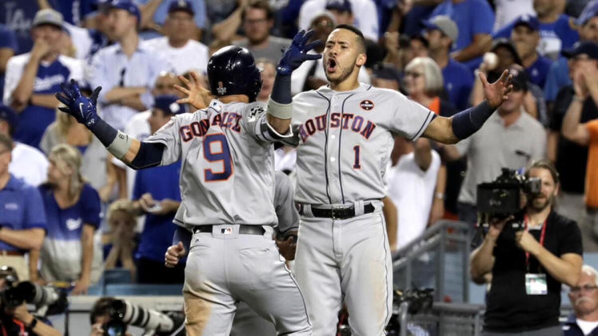 Astros shortstop Carlos Correa greets teammate Marwin Gonzalez after he hit a solo home run off Kenley Jansen.