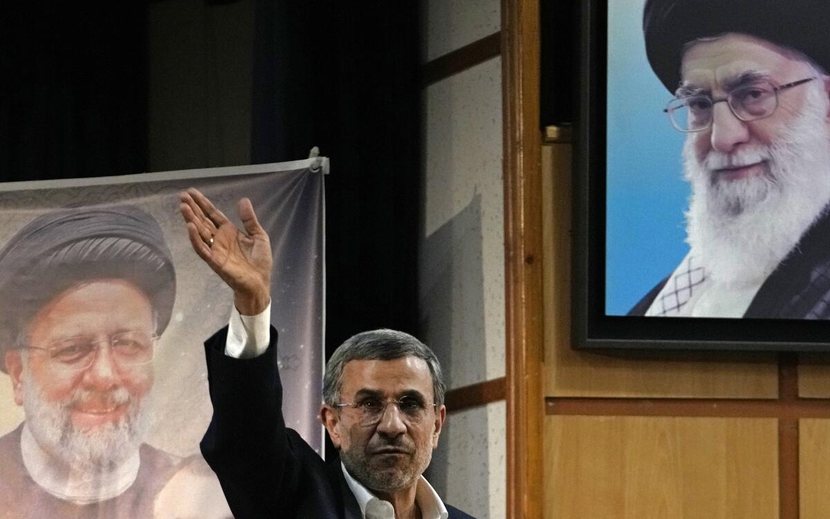 Iran's hard-line former President Mahmoud Ahmadinejad waves.