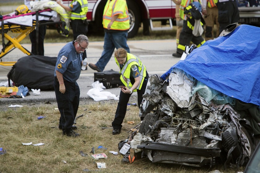 Paramedics work the scene of a deadly car crash on Route 1 near Townsend, Del., Friday, July 6, 2018.