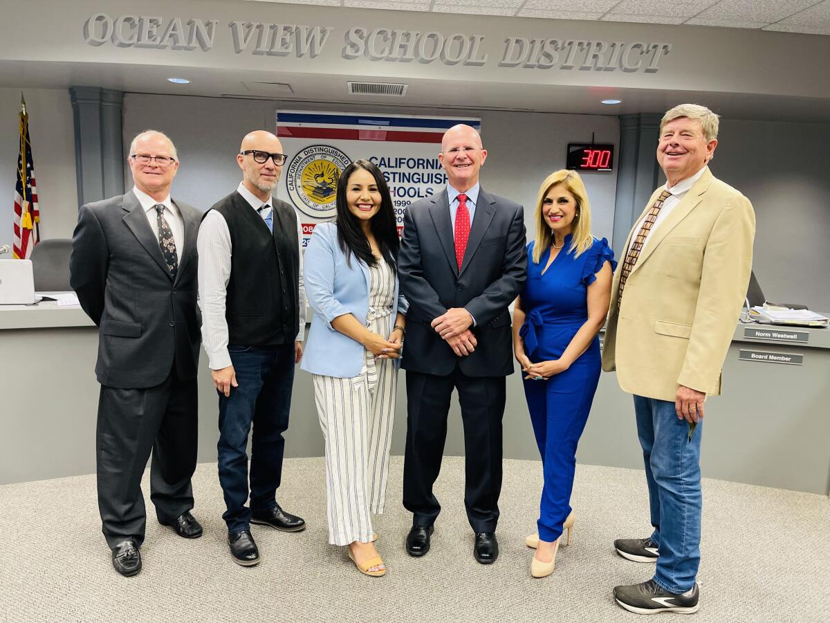 Michael Conroy, center, is pictured with the Board of Trustees after Tuesday's Ocean View School District board meeting.