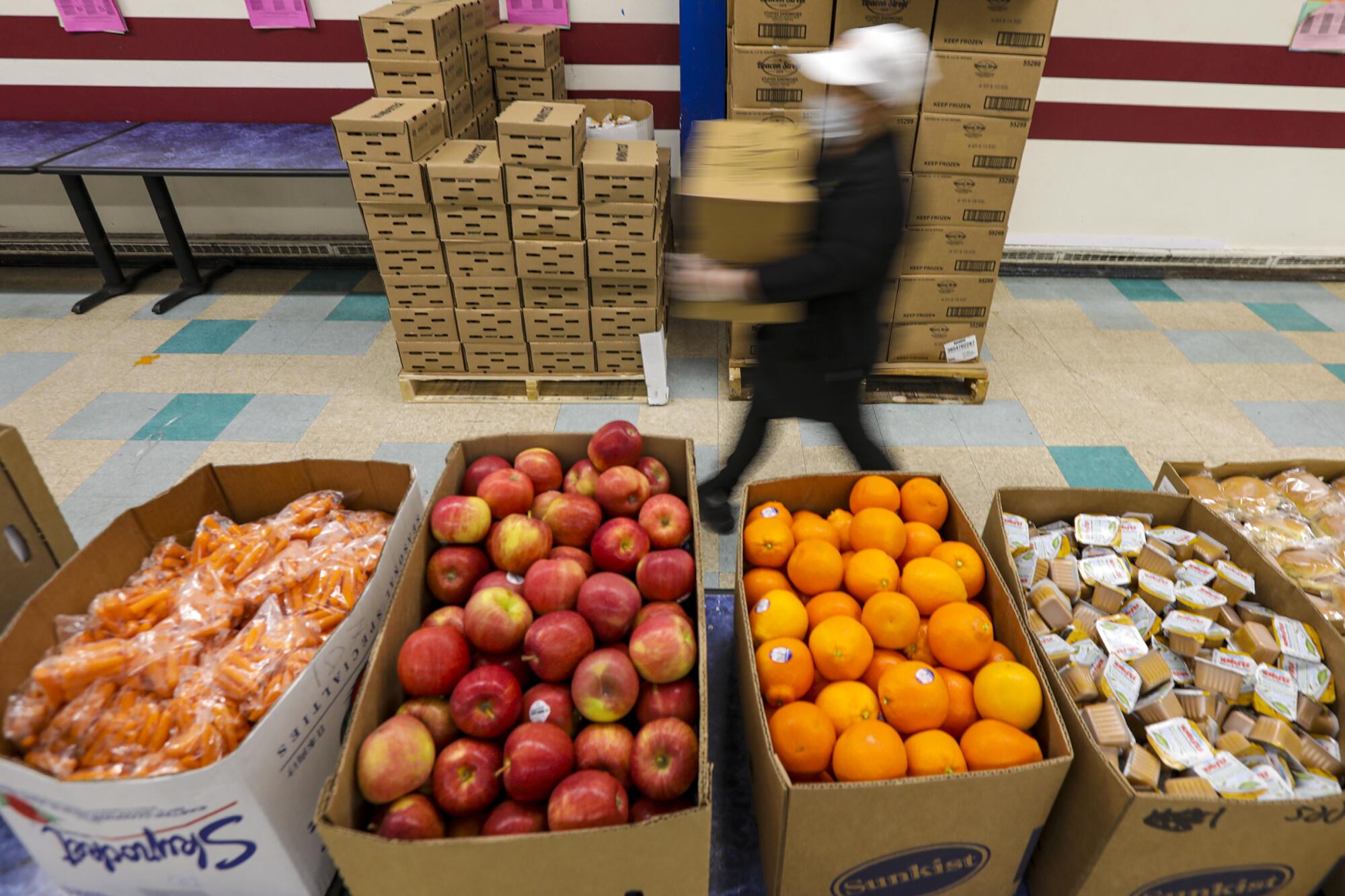 LAUSD cafeteria crew gets busy in making food bags James A. Garfield High School for distribution among area families.