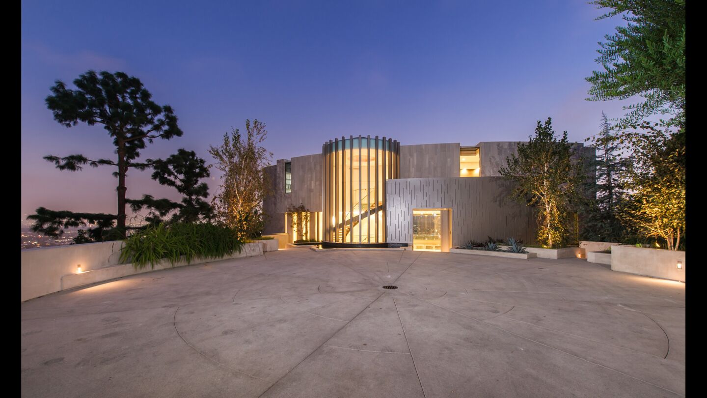 The Richard Landry-designed home in Hollywood Hills West features walls of glass, a three-story staircase and an infinity-edge swimming pool.