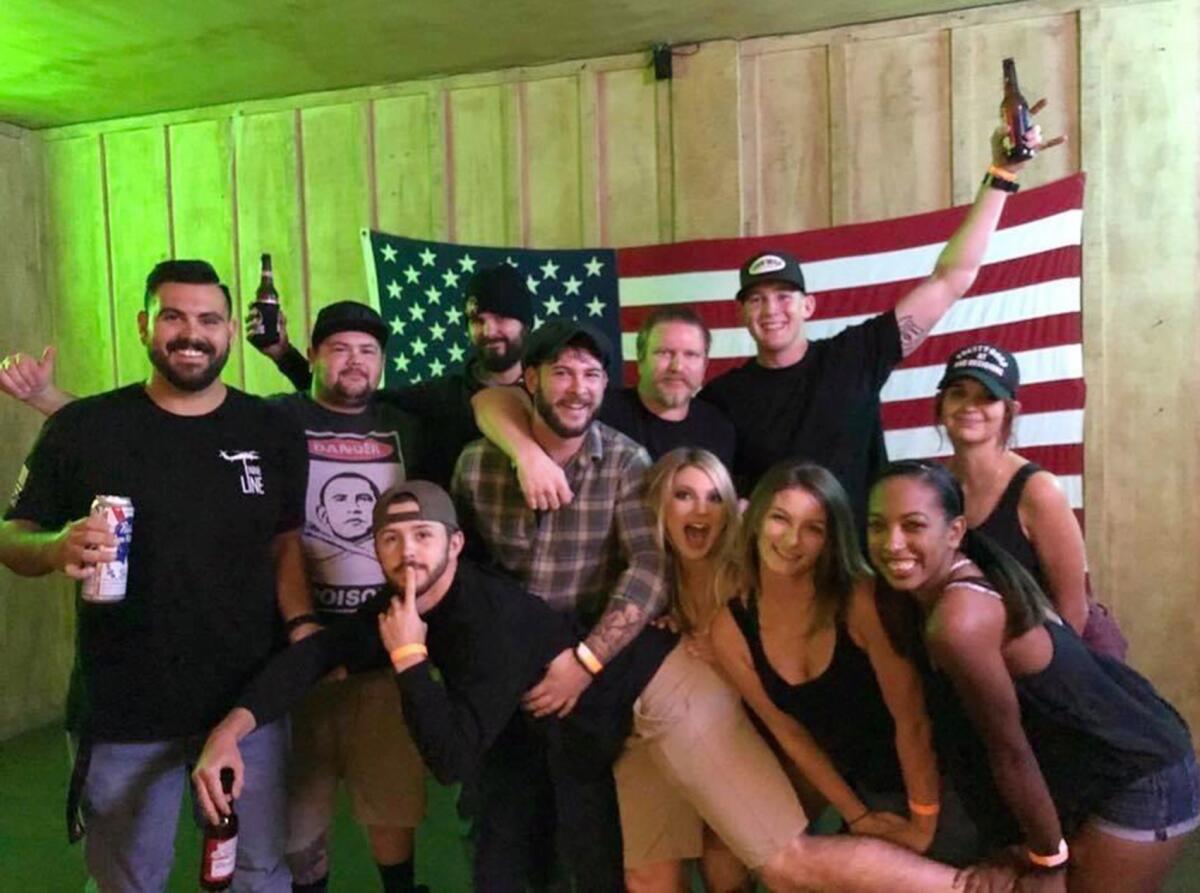 Eleven friends gather for a photo minutes before a gunman began a deadly rampage in their favorite bar. At far left is Justin Meek. In back, with his right hand raised and wearing a black beanie, is Telemachus Orfanos. At center, in the plaid shirt, is Garrett Gratland. In back at right, with his left hand raised, is Brendan Kelly.