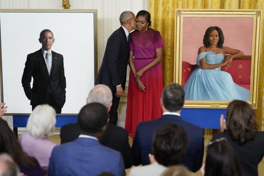Former President Barack Obama kisses his wife former first lady Michelle Obama after they unveiled their official White House portraits during a ceremony for the unveiling in the East Room of the White House, Wednesday, Sept. 7, 2022, in Washington. (AP Photo/Andrew Harnik)