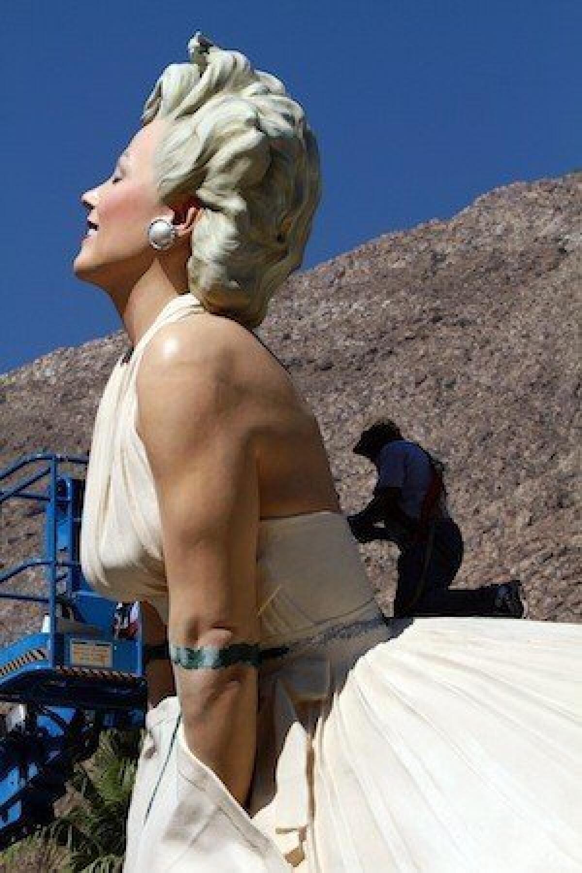A worker puts the finishing touches on "Forever Marilyn" as the statue was installed in Palm Springs last May.