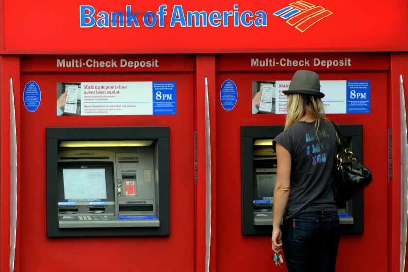 A Bank of America customer uses an ATM at a branch in Hollywood on October 19, 2010. Two top US banks are moving on the offensive as they struggle to put the foreclosures quagmire behind them, but the scandal continues to menace the financial sector. Bank of America, the country's largest bank by assets, said it was lifting freezes on more than 100,000 foreclosure cases in 23 states, insisting it had not found any flaws in their processing. Bank of America, which had announced a nationwide moratorium on foreclosures to review its paperwork on October 8, nevertheless said the freeze will stay in place for now in the remaining 27 states. AFP PHOTO/Mark RALSTON (Photo credit should read MARK RALSTON/AFP/Getty Images) ** TCN OUT **