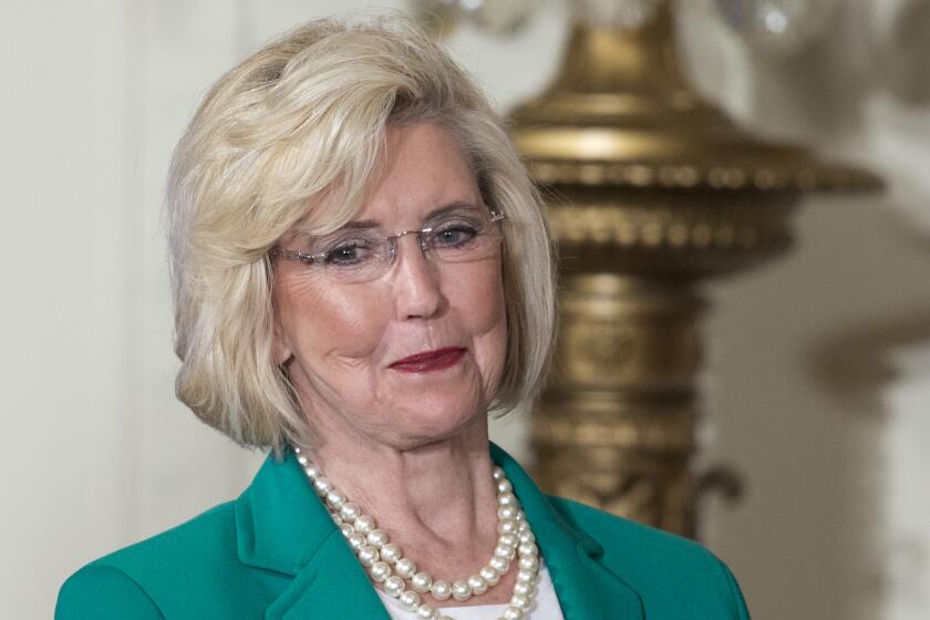 FILE - Lilly Ledbetter looks to the audience as President Barack Obama speaks in the East Room of the White House in Washington, April 8, 2014, during an event marking Equal Pay Day. (AP Photo/Carolyn Kaster, File)