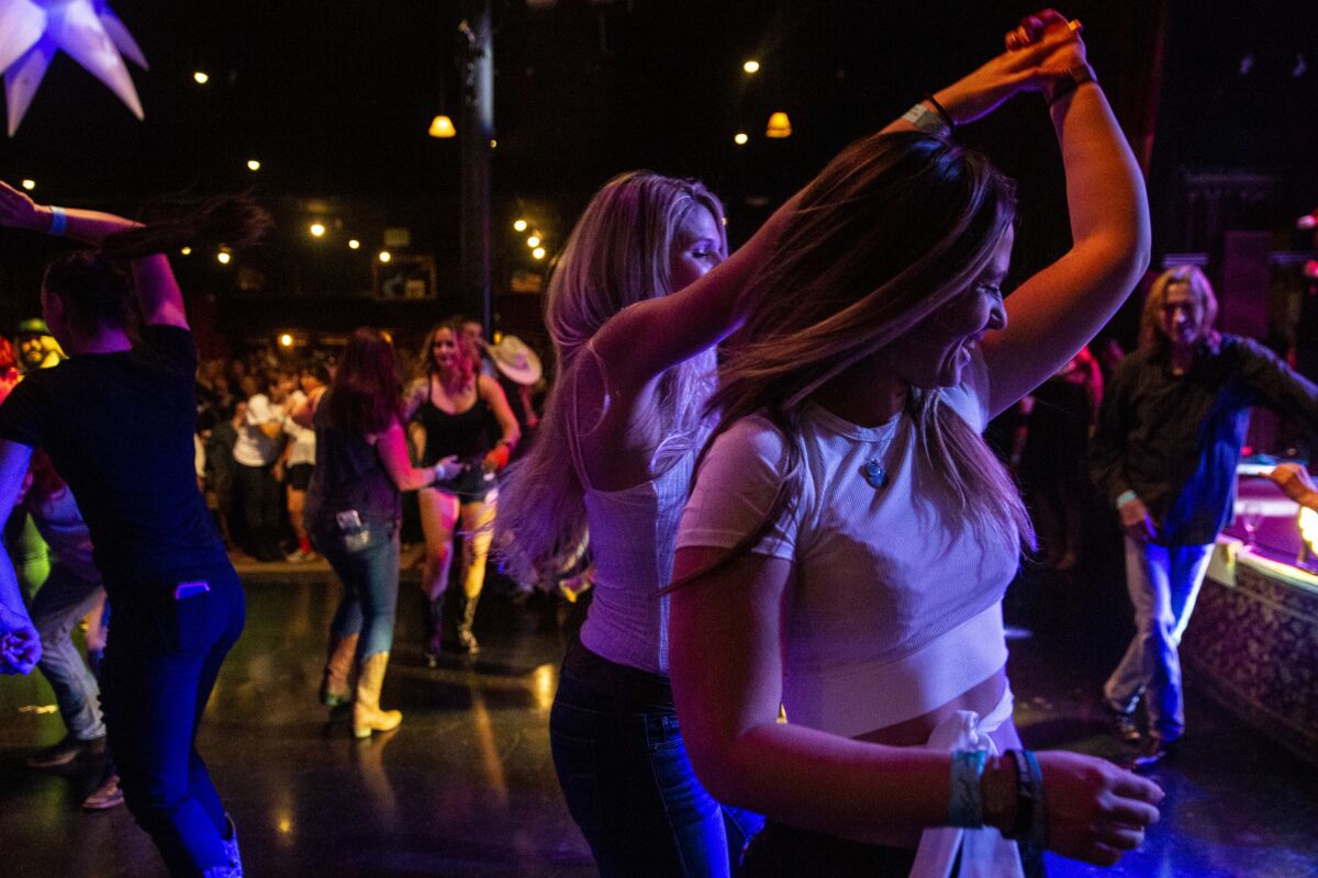 Alexis Tait, 23, of Simi Valley dances with a friend at the Borderline Country Night at The Canyon bar.