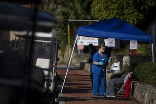 CATALINA, CALIF. - MARCH 16: A nurse takes the vital signs of a woman in a medical tent outside the hospital on Catalina, Calif. on Monday, March 16, 2020. (Francine Orr / Los Angeles Times)
