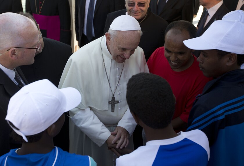 FILE - In this July 8, 2013 file photo, Pope Francis speaks to migrants, some wearing white caps, during his visit to the island of Lampedusa, southern Italy. Pope Francis on Thursday, May 6, 2021 denounced “aggressive” nationalism that rejects migrants and demanded that Catholics follow the Gospel-mandated call for an inclusive, welcoming church that doesn’t distinguish between “natives and foreigners, residents and guests.” (AP Photo/Alessandra Tarantino, pool )