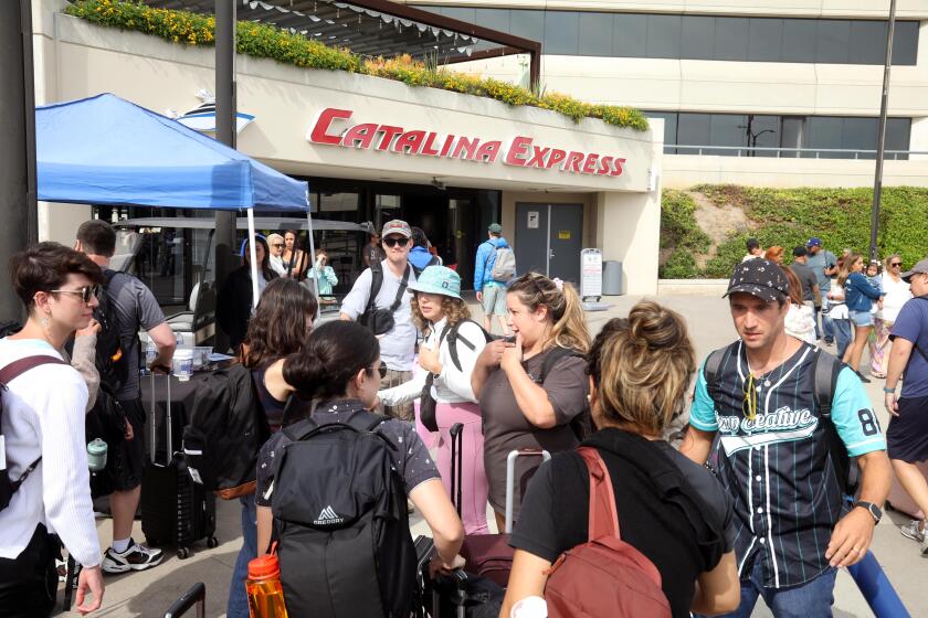 LONG BEACH, CA - AUGUST 19, 2023 - BMP Creative President Anthony Deptula, right, checks on members of his group after they were evacuated from Catalina Island to Long Beach due to Hurricane Hilary on August 19, 2023. The group were on a company retreat. (Genaro Molina / Los Angeles Times)