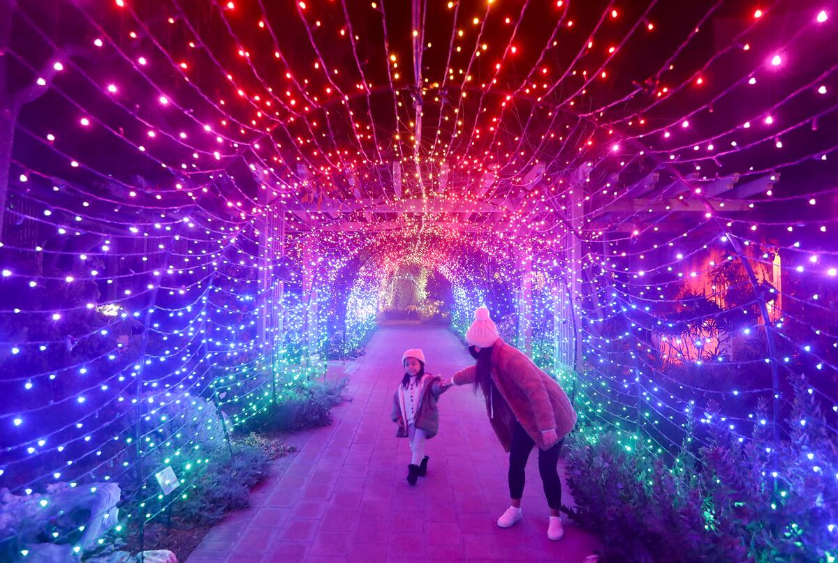 Allison Kho and her daughter Nikki, walk down the Technicolor light tunnel.